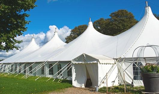 tall green portable restrooms assembled at a music festival, contributing to an organized and sanitary environment for guests in Brentwood